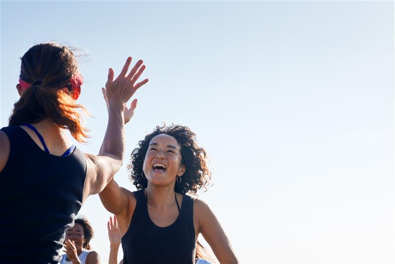 Two women high fiving