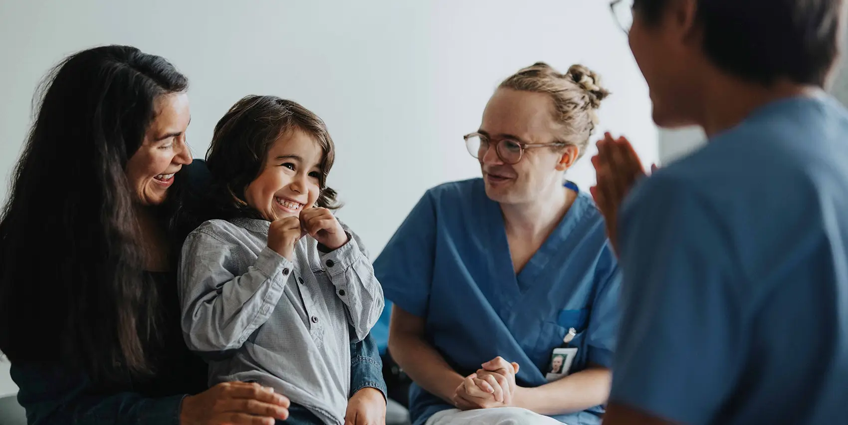 Child with parent and health care professionals