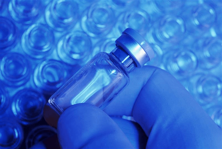 Hand holding vial