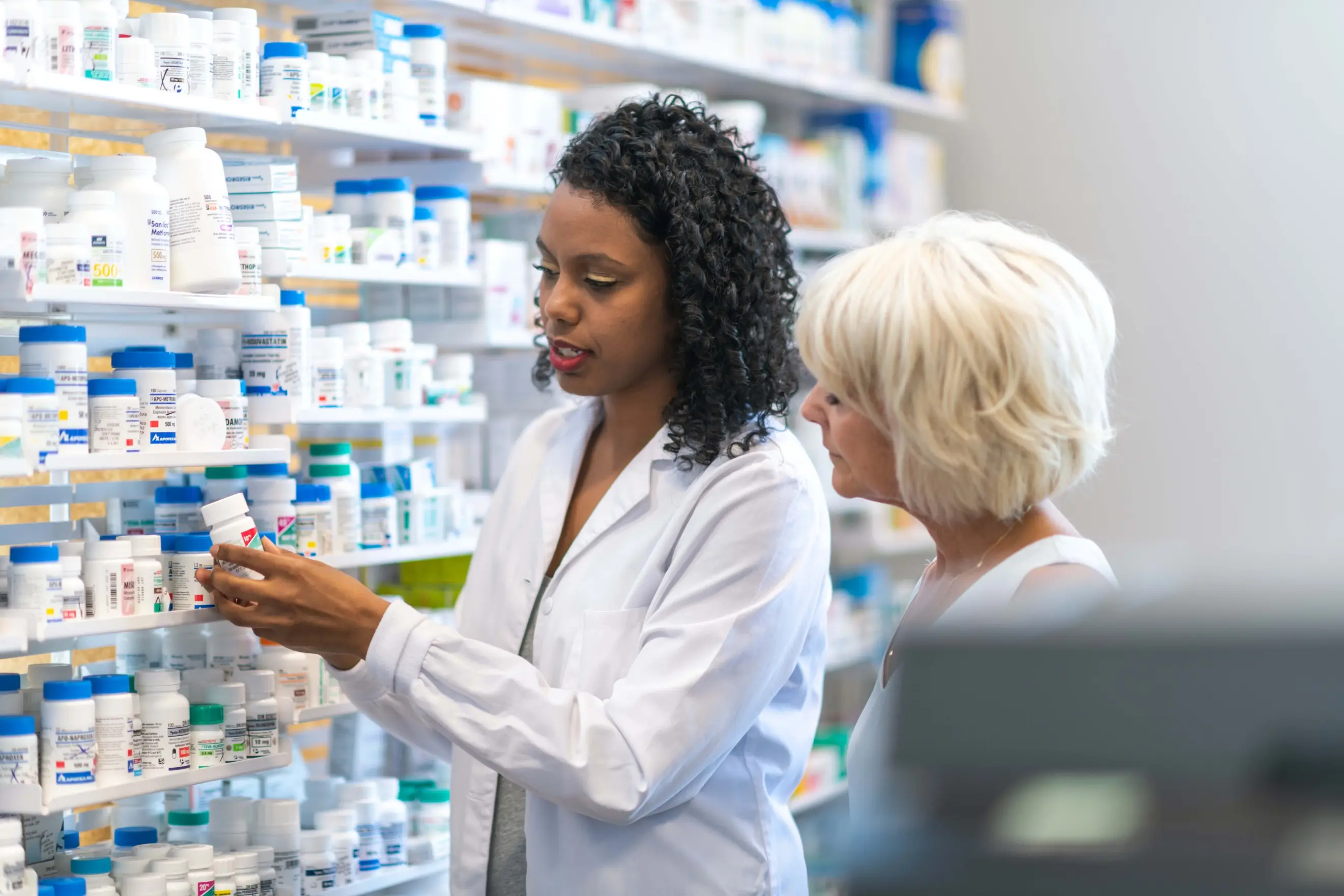 Pharmacist assisting patient Pharmacist assisting patient