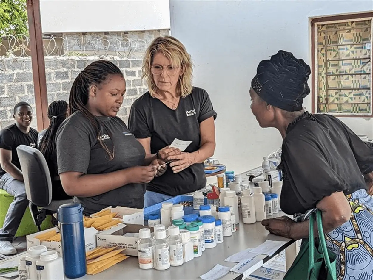 Two volunteers working at the Apotex global medicine donation program